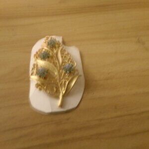 vintage gold tone brooch.with blue rhinestones.